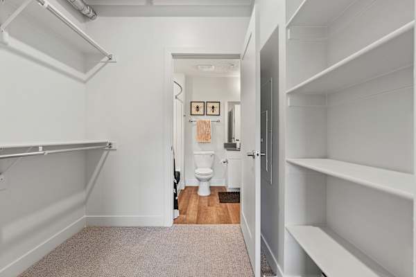 A white hallway with a toilet and a door. at The Revival, Utah